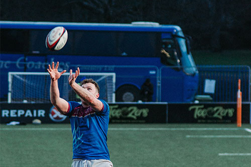 motor coach bus in a football game